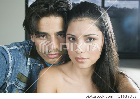 Hispanic couple hugging 11635315