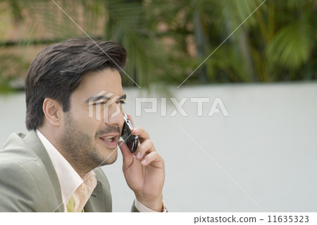 Hispanic businessman talking on cell phone 11635323