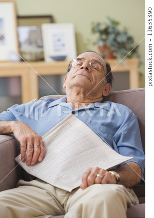 Senior Hispanic man sleeping on sofa Senior Hispanic man sleeping on sofa 11635390