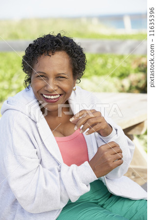 Senior woman laughing outdoors 11635396