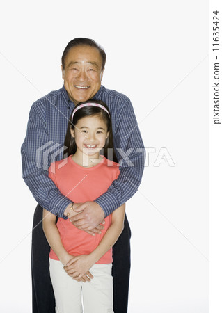 Asian grandfather hugging granddaughter 11635424