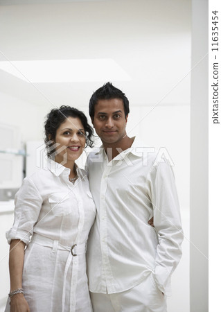 Middle Eastern couple hugging and smiling indoors 11635454