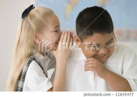 Multi-ethnic children telling secret 11635477