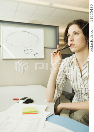 Businesswoman thinking near dry erase board with empty thought bubble on it  11635480