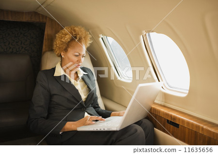African American businesswoman on airplane 11635656