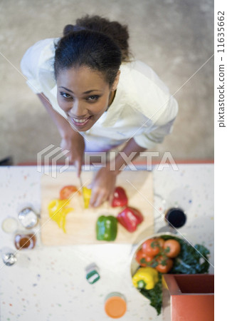 African American woman chopping vegetables African American woman chopping vegetables 11635662