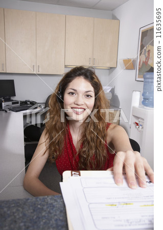 Hispanic female medical professional taking chart Hispanic female medical professional taking chart 11635695