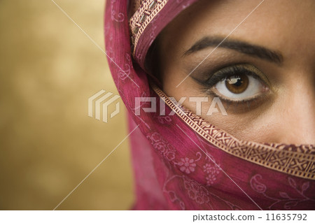 Middle Eastern woman wearing face covering 11635792