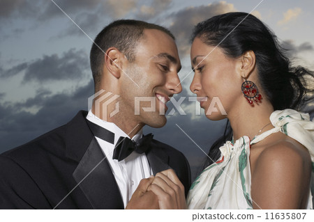 Hispanic couple smiling at each other 11635807