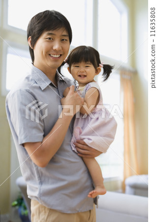 Asian father holding baby daughter 11635808