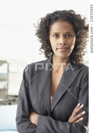 African businesswoman standing with arms crossed 11635843