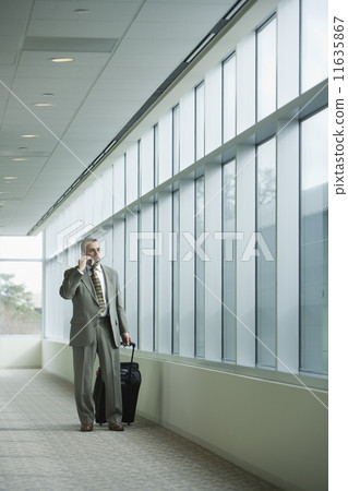 Hispanic businessman talking on cell phone Hispanic businessman talking on cell phone 11635867