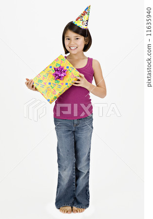 Studio shot of Asian girl with gift and party hat 11635940