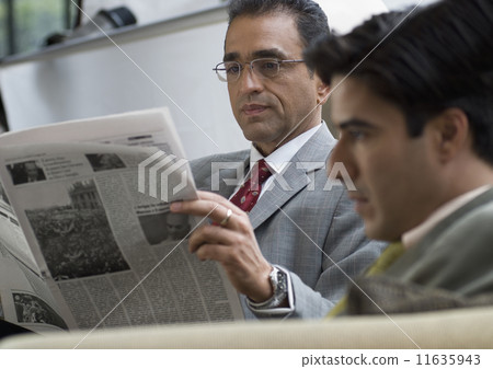 Hispanic businessman reading newspaper 11635943
