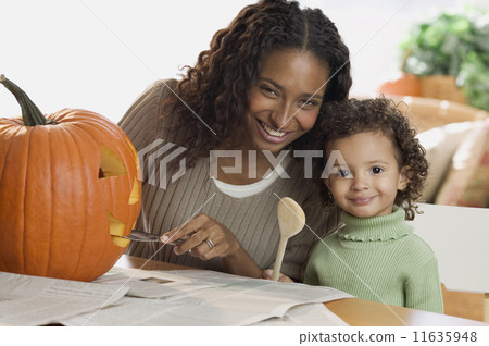 Portrait of mother and daughter carving pumpkin Portrait of mother and daughter carving pumpkin 11635948