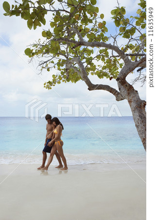 South American couple walking on beach South American couple walking on beach 11635949