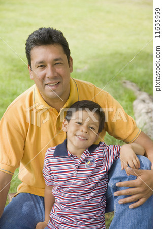 Hispanic father and son outdoors 11635959