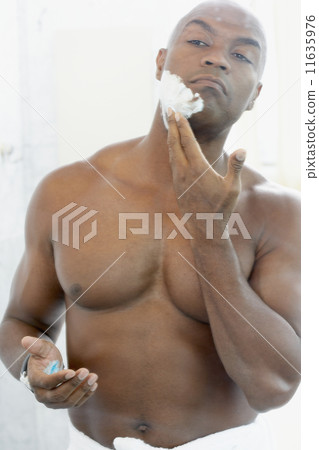 African American man applying shaving cream African American man applying shaving cream 11635976