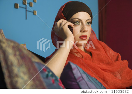 Middle Eastern woman talking on cell phone Middle Eastern woman talking on cell phone 11635982
