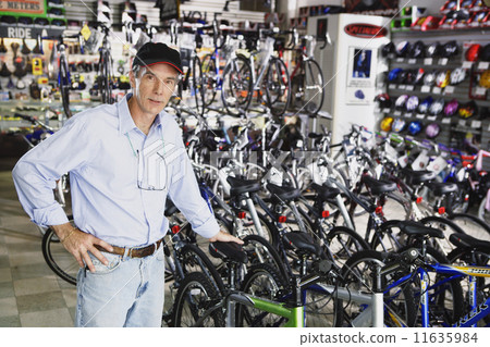 Portrait of man standing in bike shop 11635984
