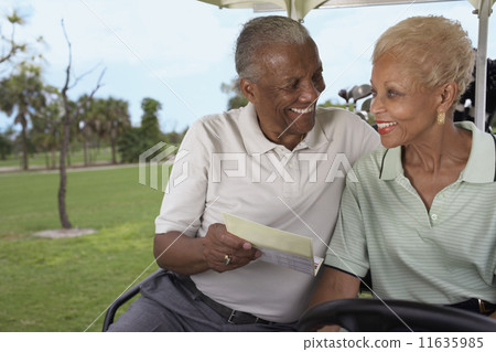 Senior African American couple in golf cart Senior African American couple in golf cart 11635985