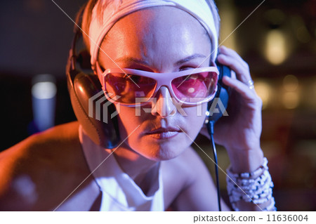 Hispanic woman wearing headphones Hispanic woman wearing headphones 11636004