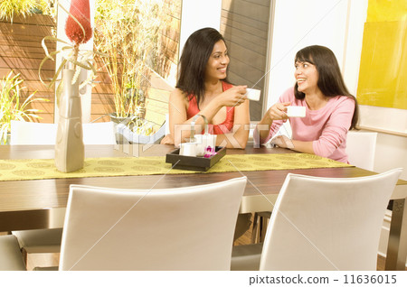 Hispanic women drinking coffee Hispanic women drinking coffee 11636015