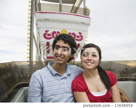 Multi-ethnic teenaged couple on carnival ride 11636058