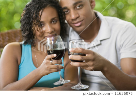 African couple toasting with wine African couple toasting with wine 11636075