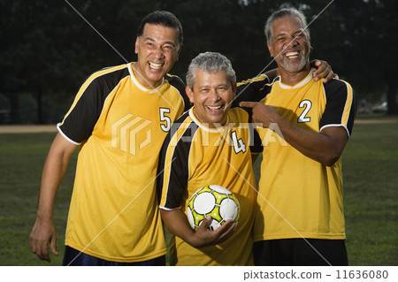 Multi-ethnic men holding soccer ball Multi-ethnic men holding soccer ball 11636080