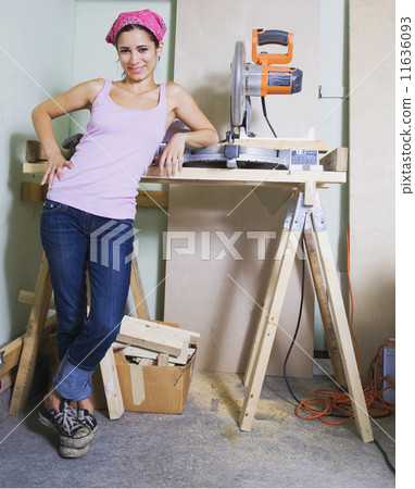Middle Eastern woman next to table saw 11636093