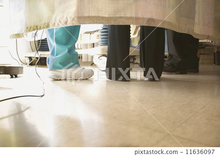 Doctors and nurses feet under curtain 11636097