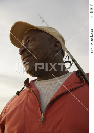 Low angle view of African man holding fishing pole 11636107