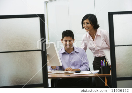Asian businesswoman and businessman looking at computer 11636132
