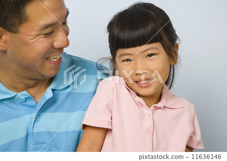 Asian father smiling at daughter 11636146