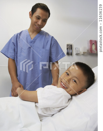 Asian boy smiling with male nurse in hospital Asian boy smiling with male nurse in hospital 11636159