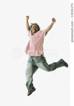 Studio shot of African man jumping Studio shot of African man jumping 11636174