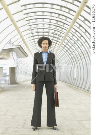 Full length portrait of businesswoman in walkway Full length portrait of businesswoman in walkway 11636176