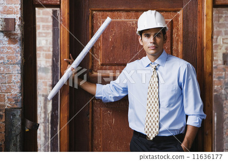 Hispanic businessman wearing hard hat Hispanic businessman wearing hard hat 11636177