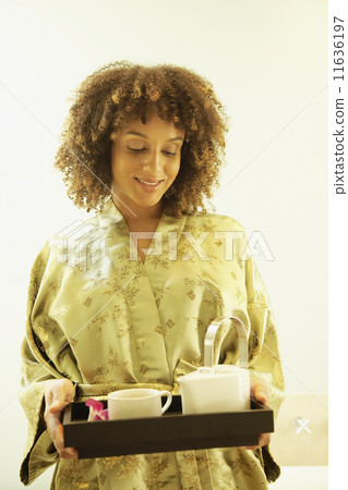 African American woman carrying tea tray African American woman carrying tea tray 11636197