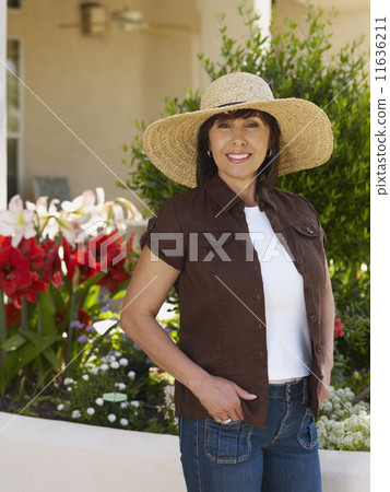 Hispanic woman wearing sunhat Hispanic woman wearing sunhat 11636211