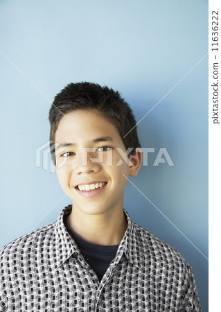 Studio shot of Asian boy smiling Studio shot of Asian boy smiling 11636222