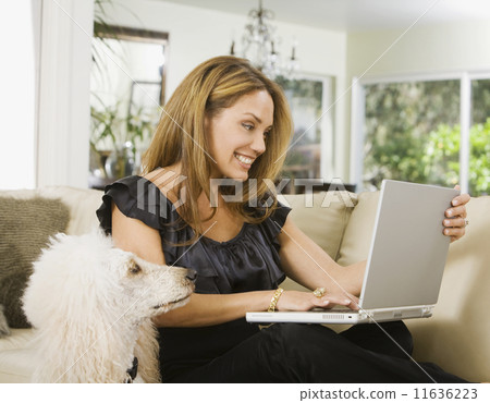 Hispanic woman looking at laptop Hispanic woman looking at laptop 11636223