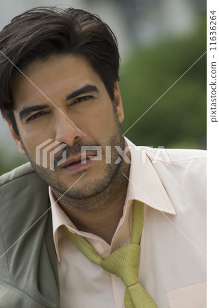 Hispanic businessman with jacket over shoulder 11636264
