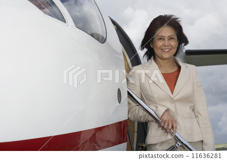 Asian businesswoman exiting airplane 11636281