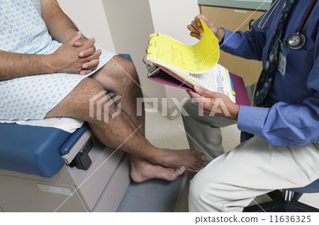 Low section of male doctor with patient Low section of male doctor with patient 11636325