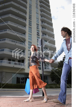 Multi-ethnic couple holding hands 11636408
