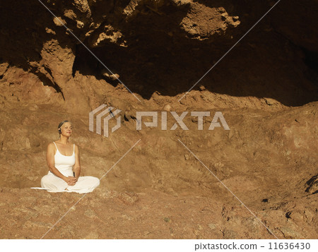 Senior Hispanic woman meditating Senior Hispanic woman meditating 11636430