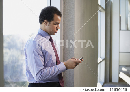 African American businessman using cell phone 11636456