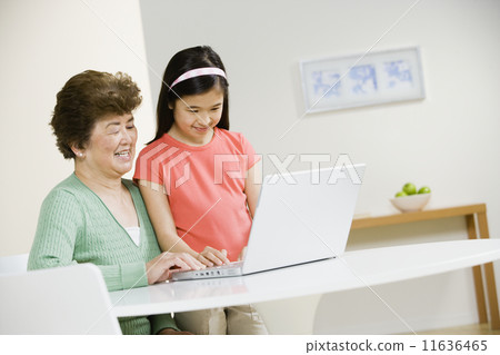 Asian grandmother and granddaughter looking at laptop Asian grandmother and granddaughter looking at laptop 11636465